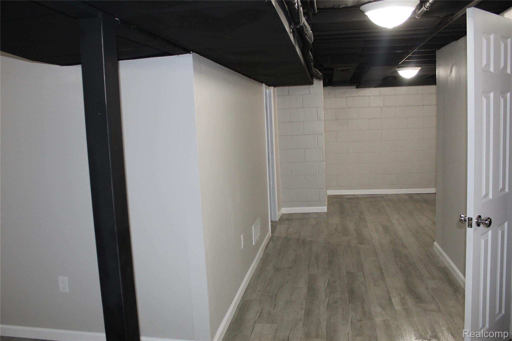 5543 Balfour Road Detroit, MI 48224 - Photo 33 of 54 Finished basement space featuring wood-finish flooring, painted cinder block walls, and recessed lighting