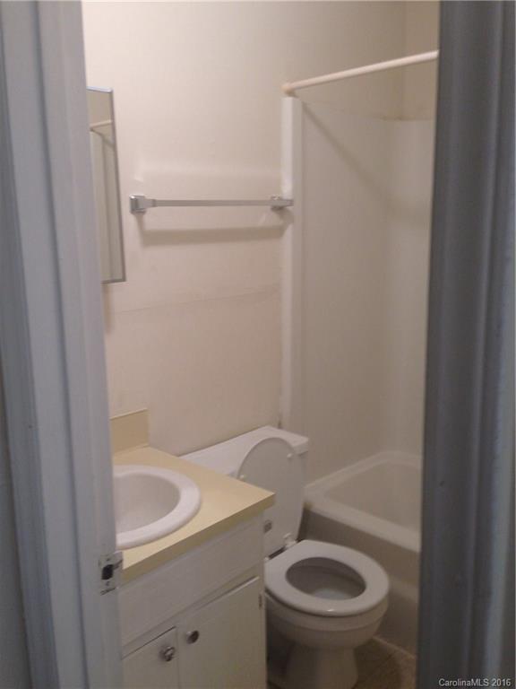713 Castle Road, Unit B Monroe, NC 28110 - Photo 5 of 5 a bathroom with a sink a toilet and shower