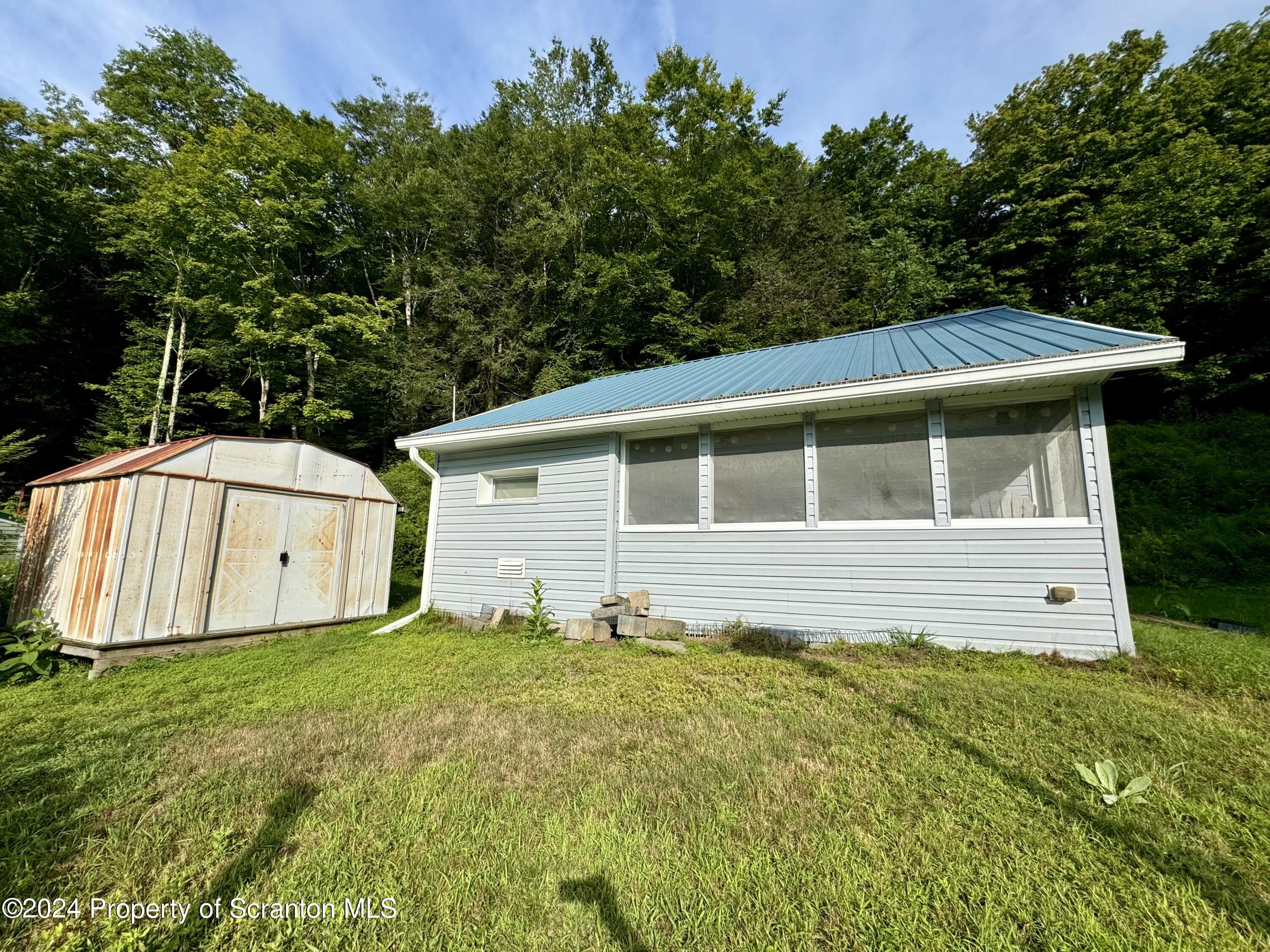 266 Crescent Lake Road Meshoppen, PA 18630 - Photo 4 of 12 a backyard of a house with yard and trampoline