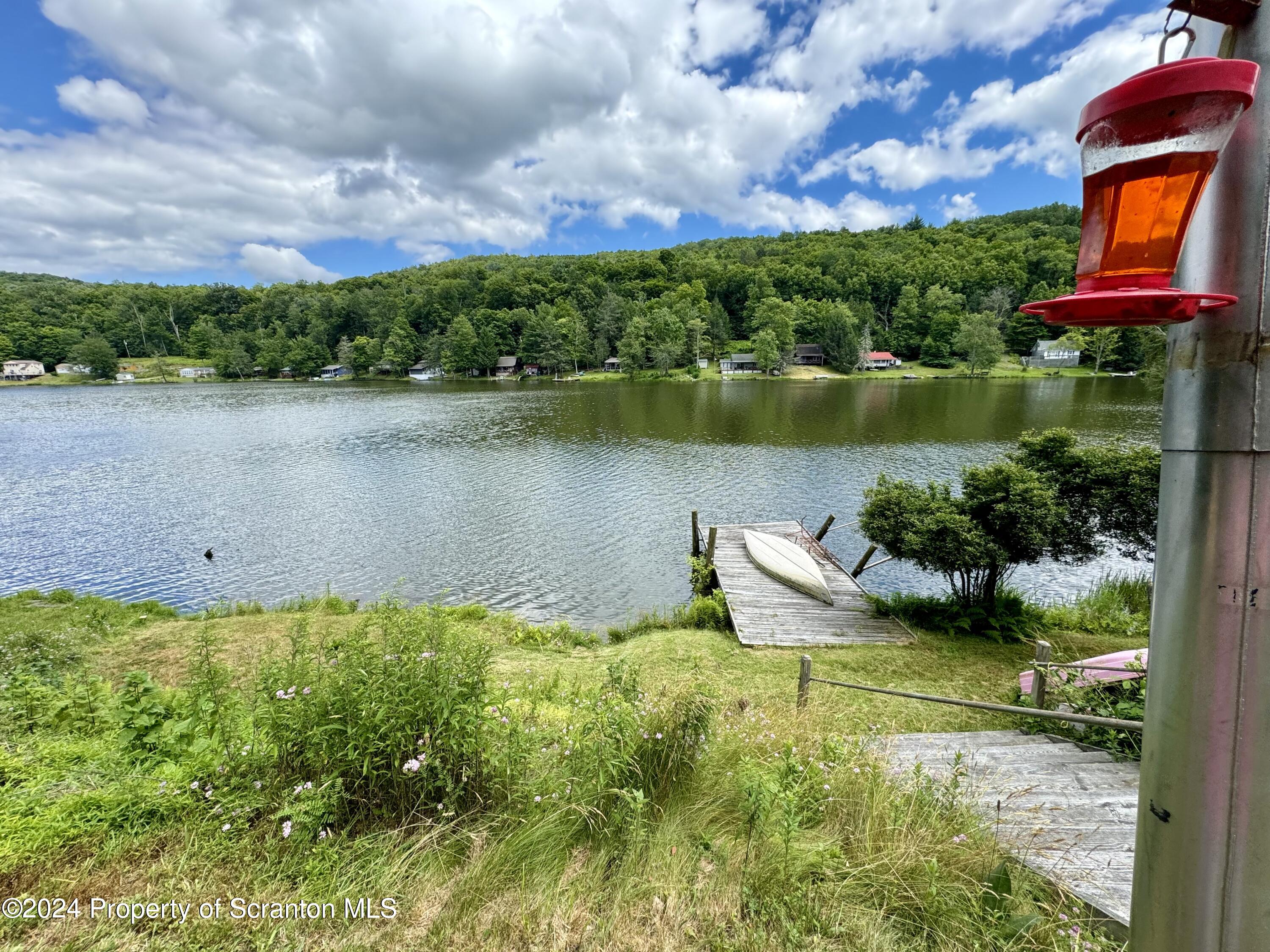 266 Crescent Lake Road Meshoppen, PA 18630 - Photo 5 of 12 a view of a lake with a house in the background