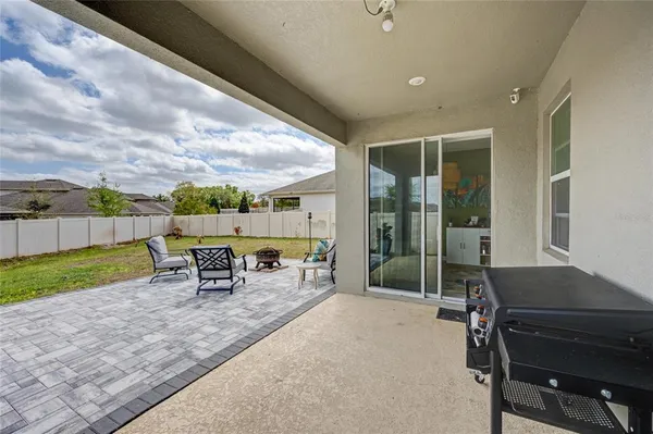 a backyard of a house with table and chairs