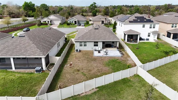 an aerial view of house with yard and ocean view