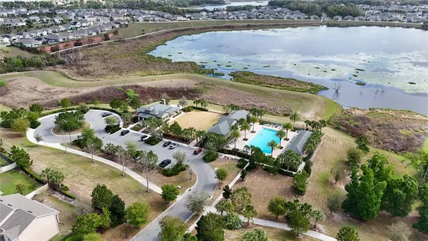 a front view of a building with large trees
