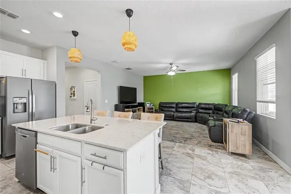 a kitchen with stainless steel appliances granite countertop a stove and a sink