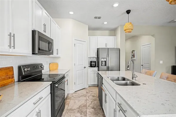 a living room with furniture and kitchen view