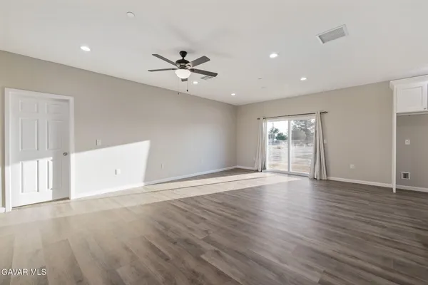 a view of an empty room with a kitchen