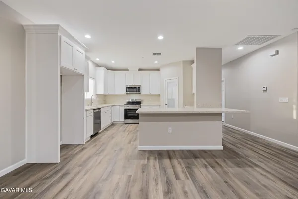 a kitchen with a sink stove and cabinets