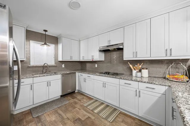 a kitchen with sink cabinets and window