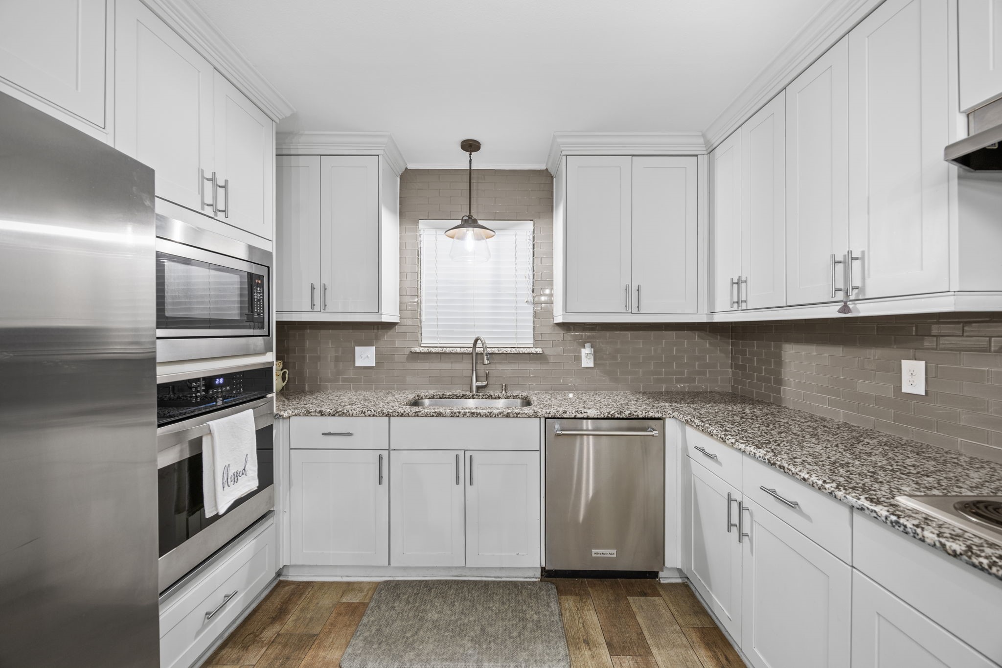 3311 Eula Morgan Road Katy, TX 77493 - Photo 16 of 32 a kitchen with stainless steel appliances granite countertop a sink and dishwasher a stove top oven with white cabinets
