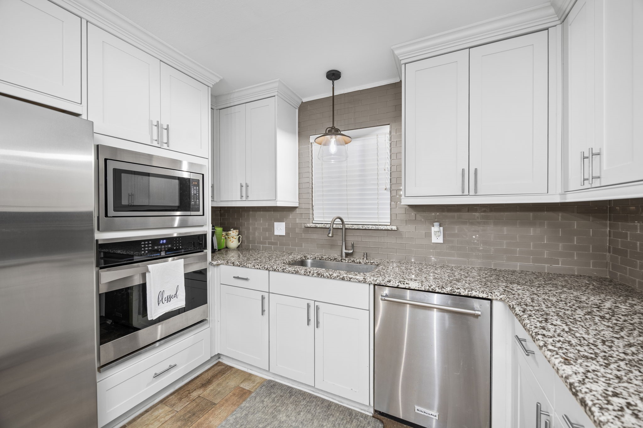 3311 Eula Morgan Road Katy, TX 77493 - Photo 18 of 32 a kitchen with granite countertop white cabinets and stainless steel appliances