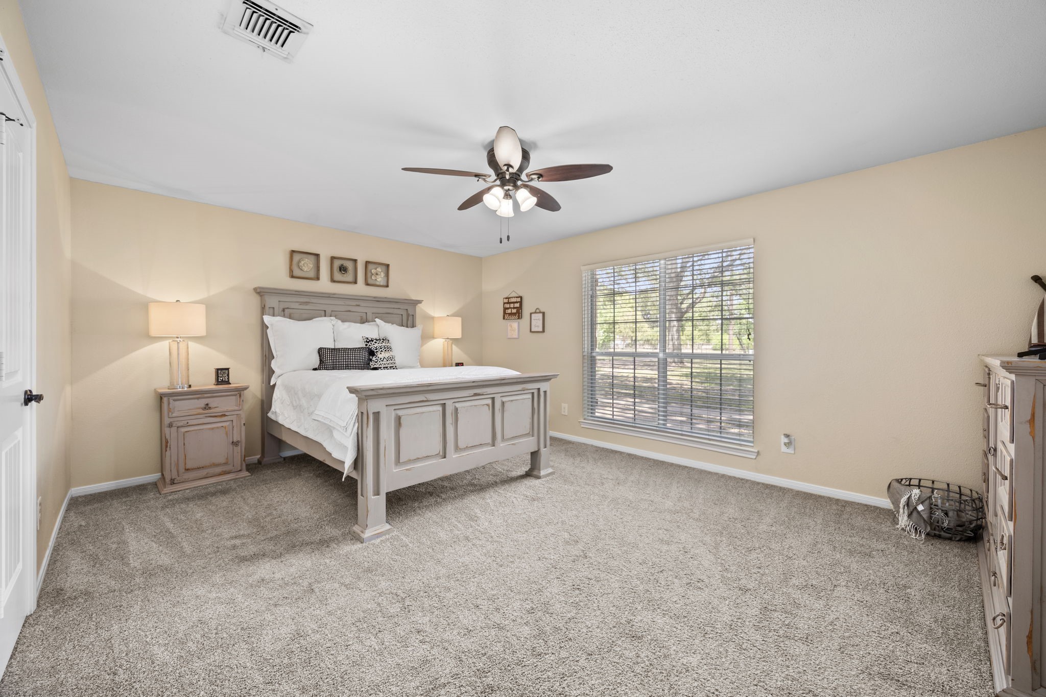 3311 Eula Morgan Road Katy, TX 77493 - Photo 23 of 32 a spacious bedroom with a bed and a ceiling fan