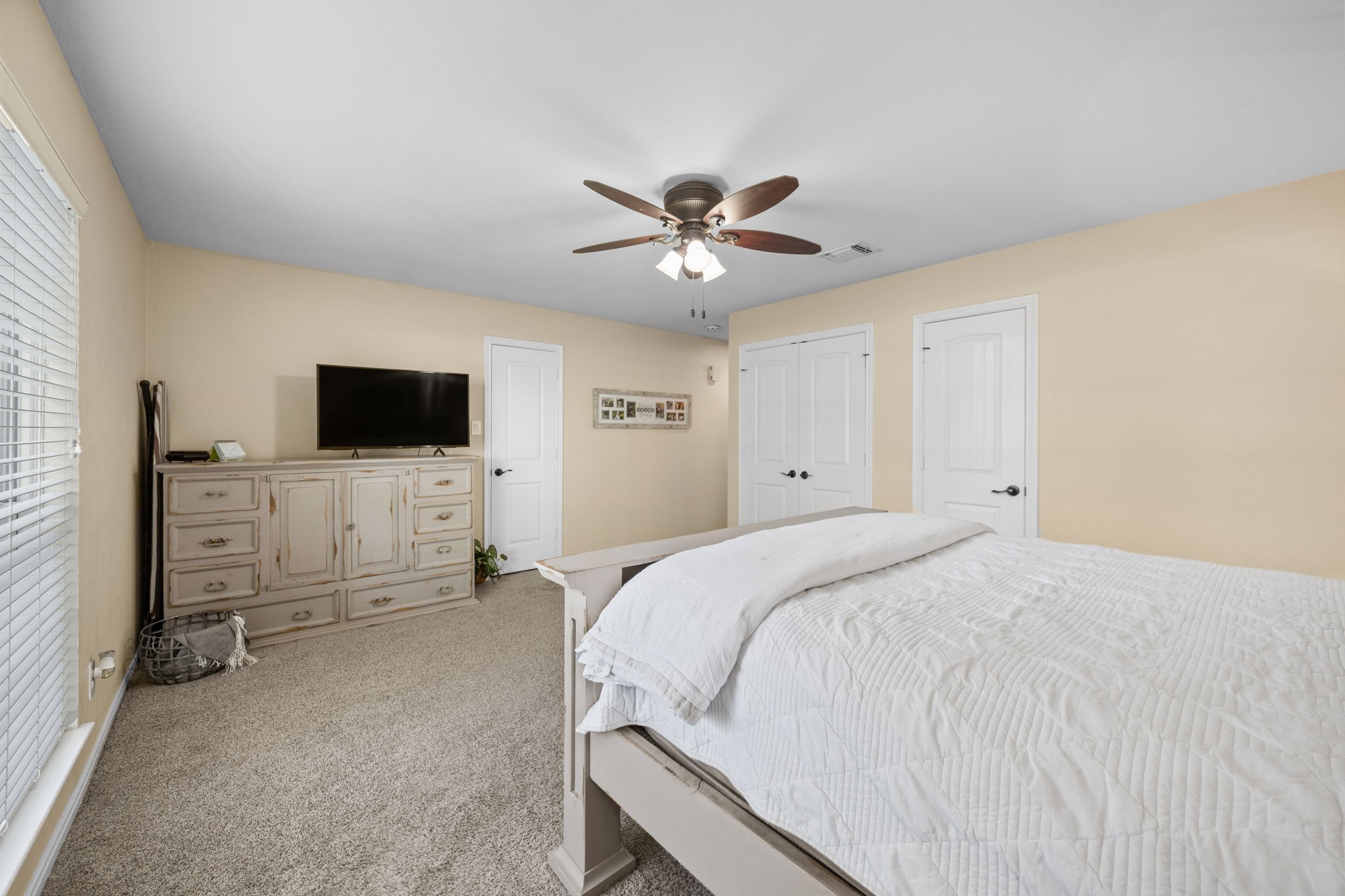 3311 Eula Morgan Road Katy, TX 77493 - Photo 24 of 32 a spacious bedroom with a bed and a flat screen tv