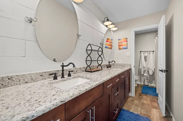 a bathroom with a double vanity sink and a mirror