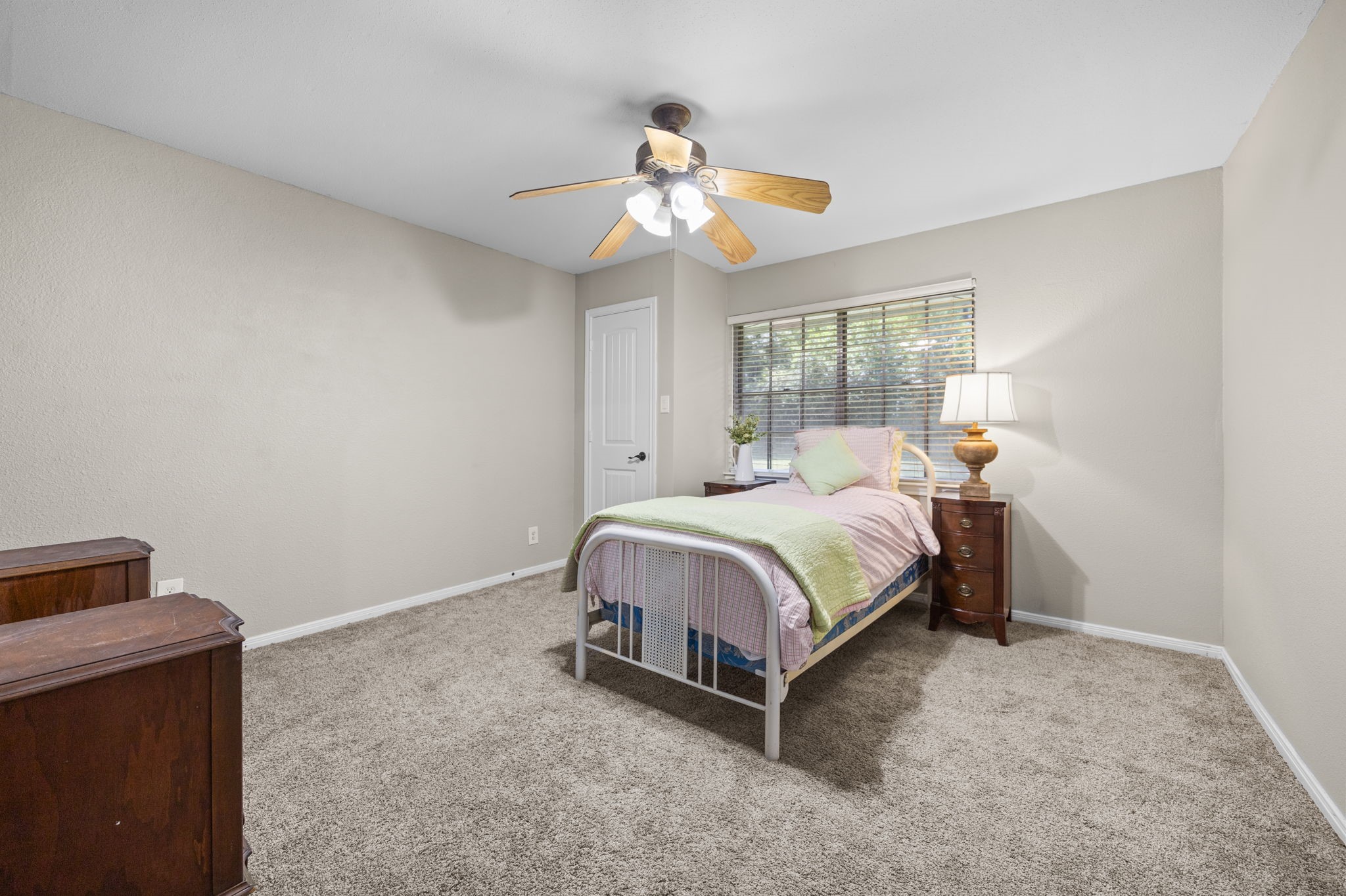 3311 Eula Morgan Road Katy, TX 77493 - Photo 28 of 32 a spacious bedroom with a bed and a chandelier