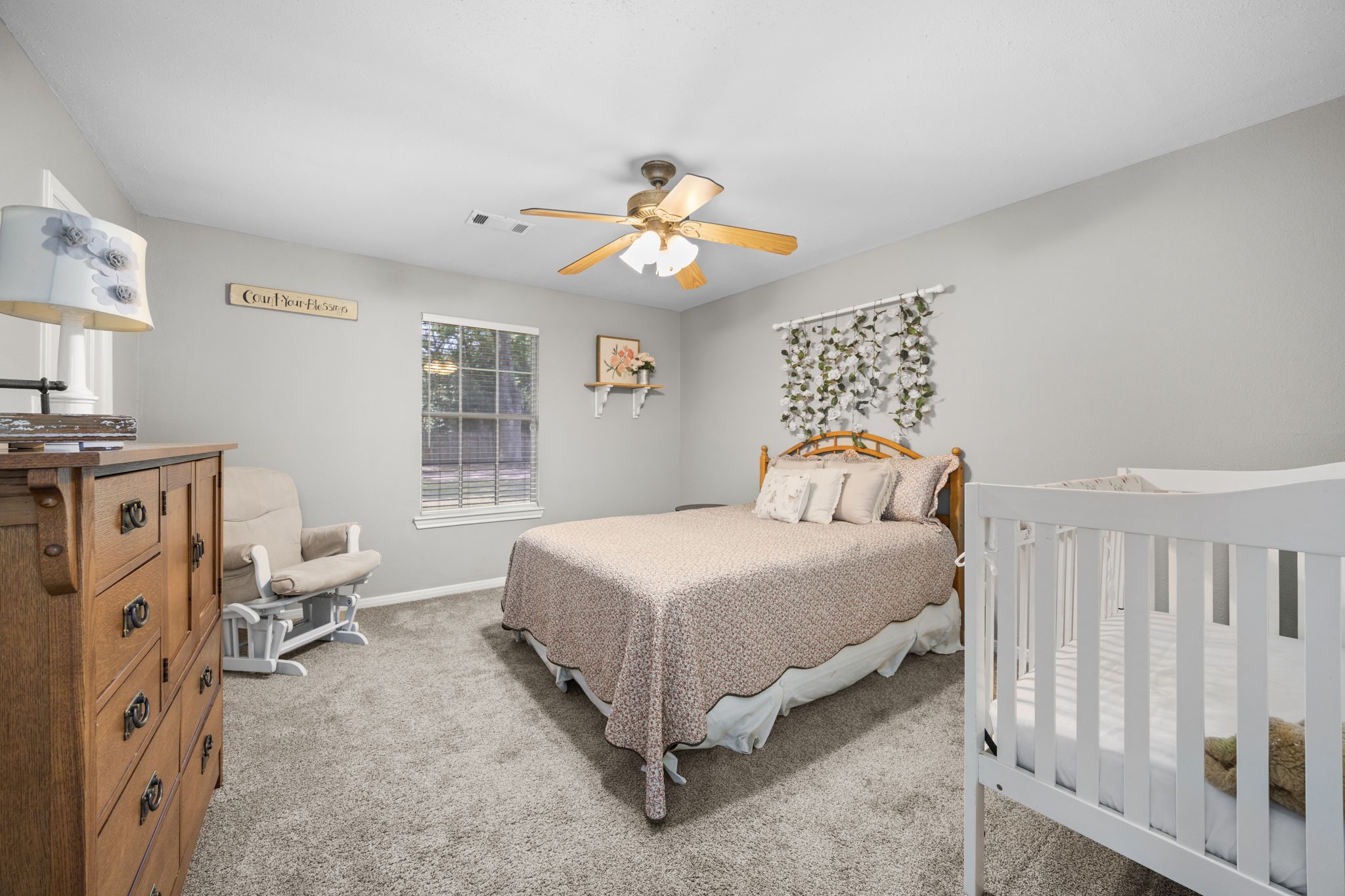 3311 Eula Morgan Road Katy, TX 77493 - Photo 29 of 32 a bedroom with a bed and a chandelier