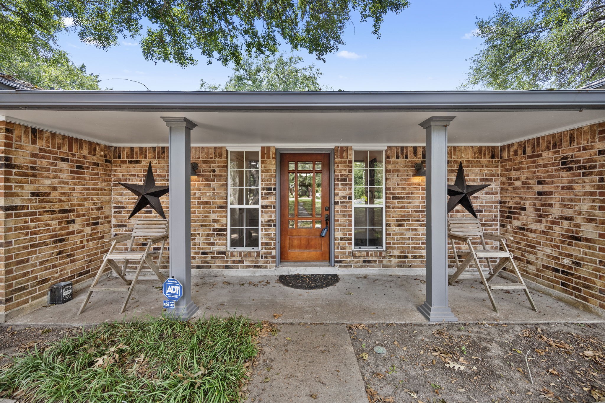 3311 Eula Morgan Road Katy, TX 77493 - Photo 7 of 32 a front view of a house with a large window and potted plants