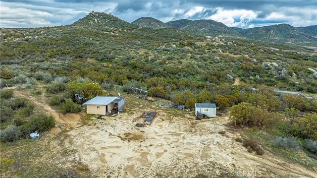 a view of a house with a yard and a wooden fence