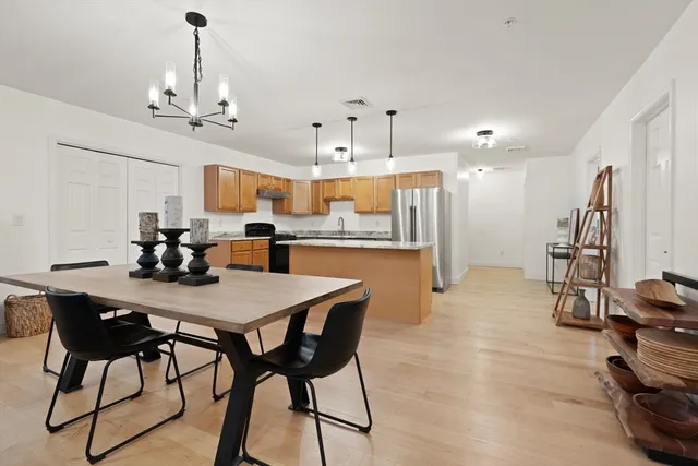 a view of a dining room with furniture and a chandelier