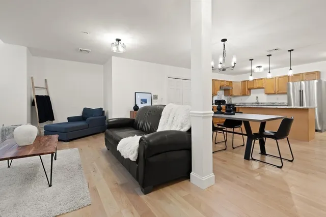 a living room with furniture and a kitchen view