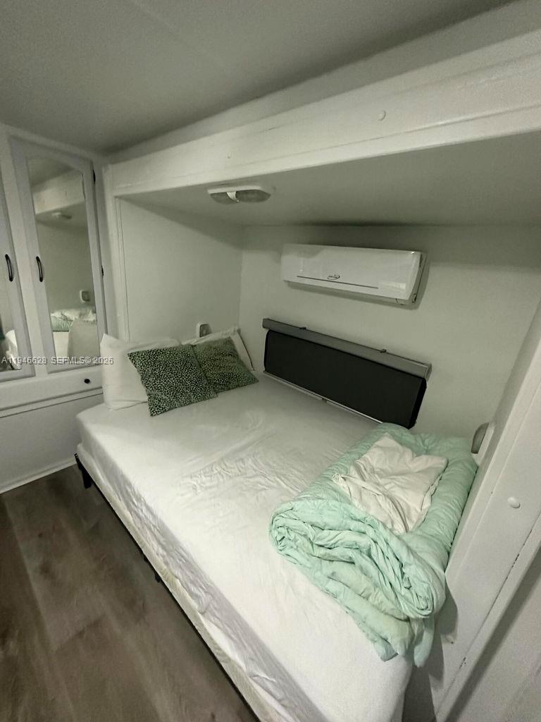 325 Calusa, Unit 9 Key Largo, FL 33037 - Photo 8 of 11 a bedroom with a bed and a window