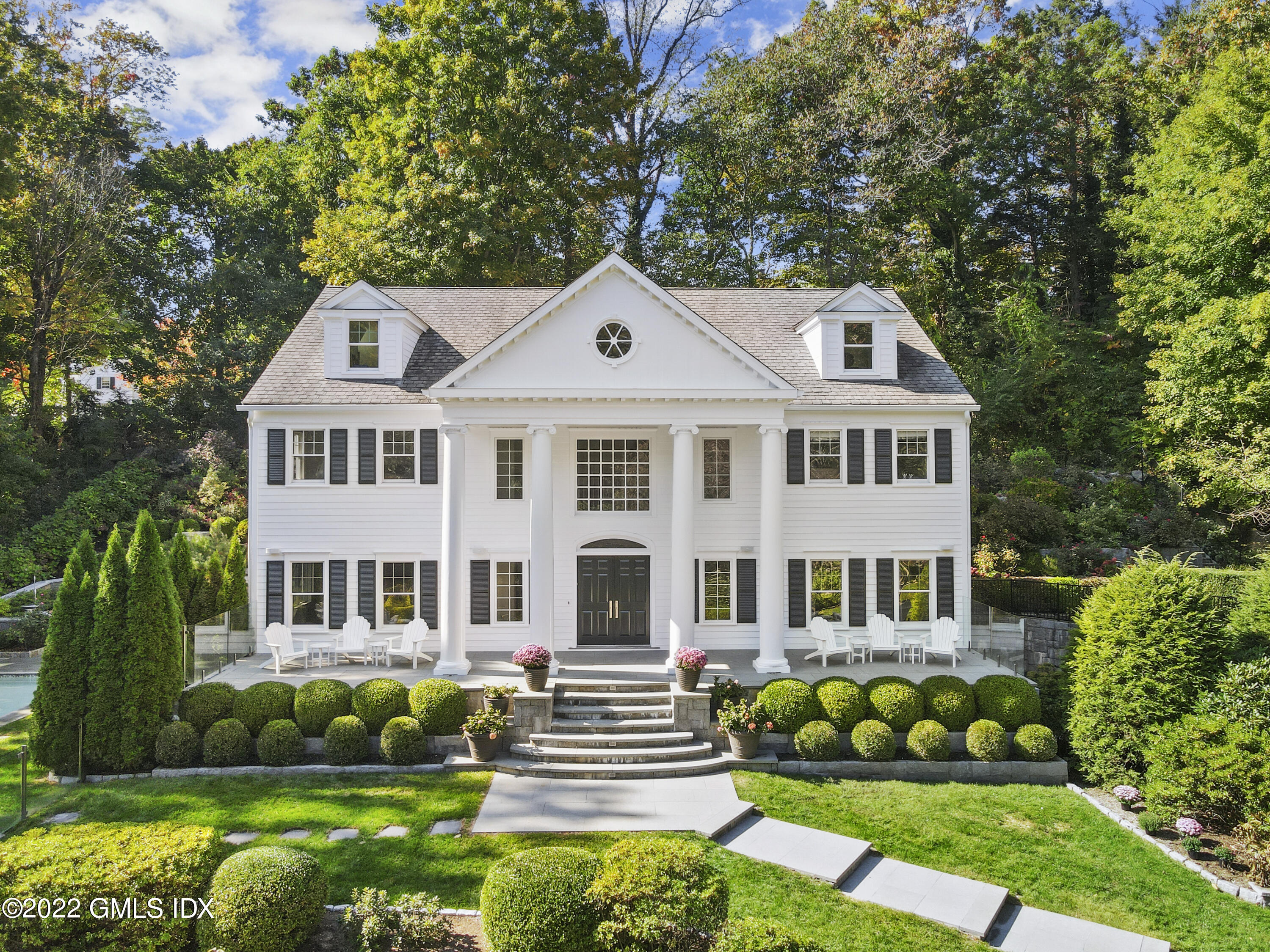a front view of a house with garden