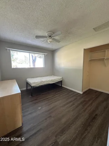 a bedroom with a bed and a dresser