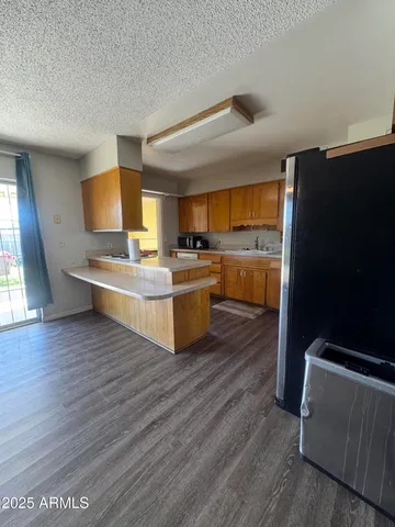 a kitchen with stainless steel appliances wooden floors and wooden cabinets