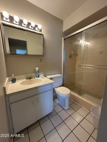 a spacious bathroom with a granite countertop sink and a large mirror