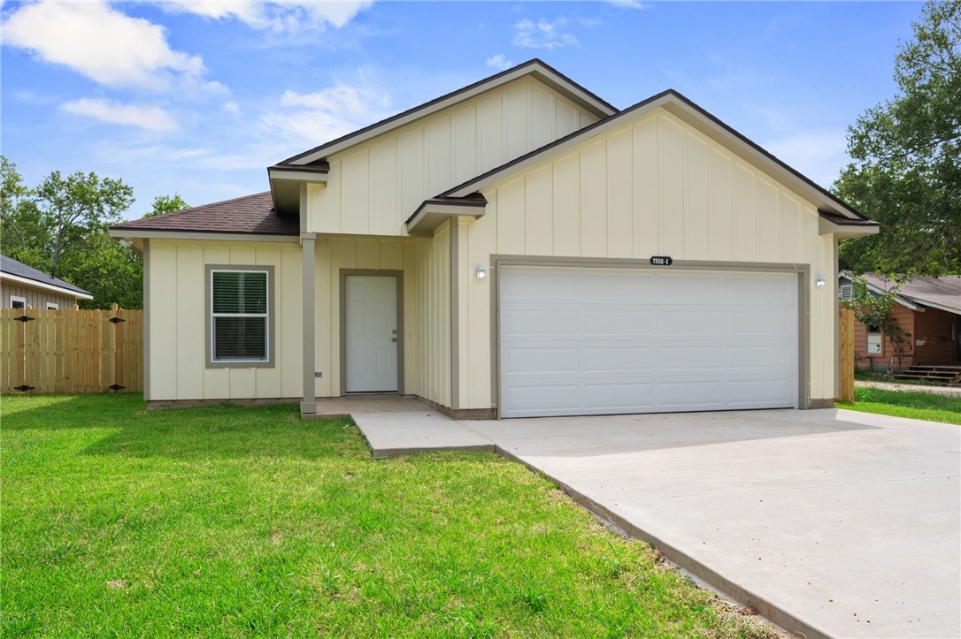 Ranch-style house with a garage, concrete driveway, and board and batten siding