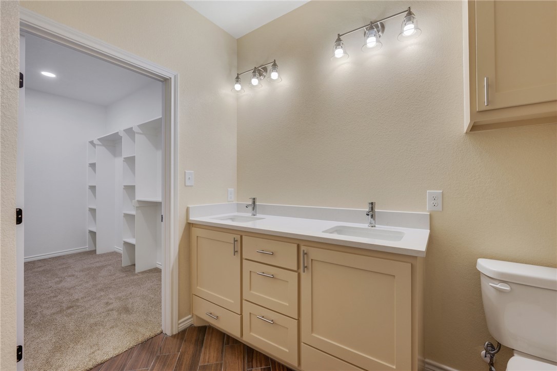 1108 Richard Street, Unit A Bryan, TX 77803 - Photo 17 of 22 Bathroom with double vanity and wood finished floors