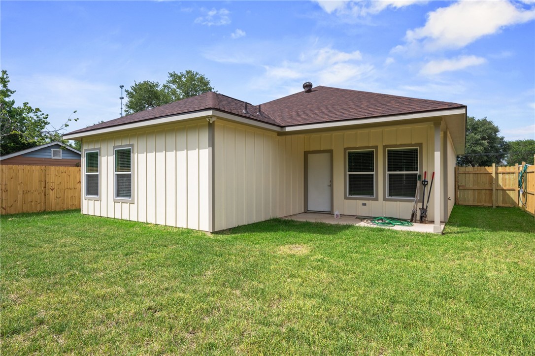 1108 Richard Street, Unit A Bryan, TX 77803 - Photo 21 of 22 Rear view of property with a fenced backyard, a patio area, a shingled roof, and board and batten siding