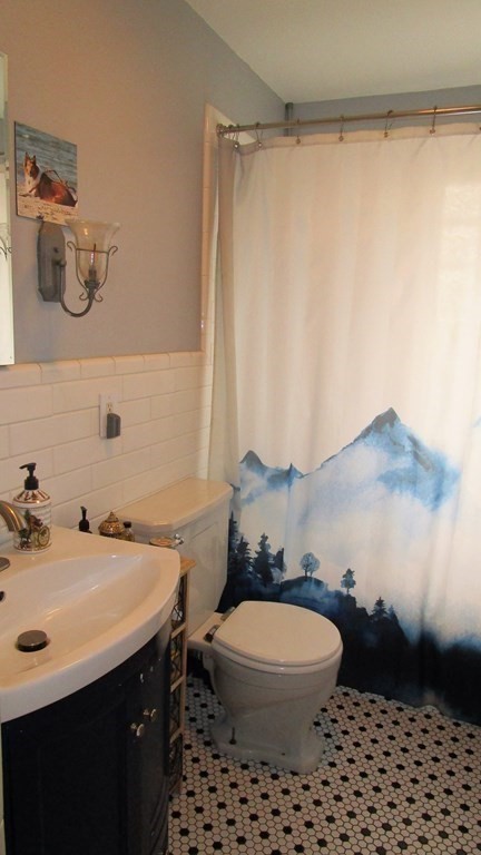 45 Upton Street Springfield, MA 01104 - Photo 12 of 19 a bathroom with a sink a toilet and a mirror