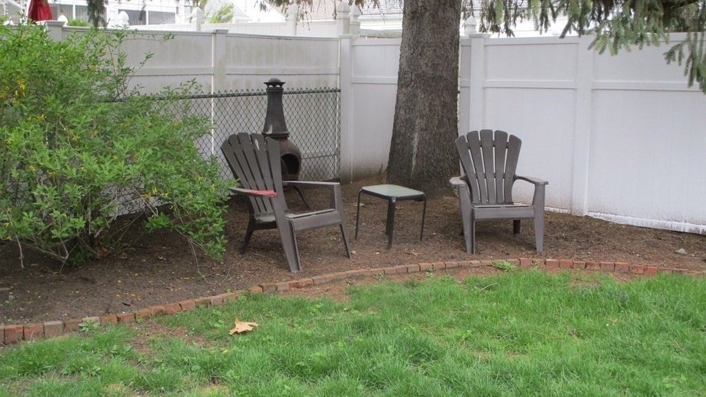 45 Upton Street Springfield, MA 01104 - Photo 4 of 19 a view of a chairs and table in backyard