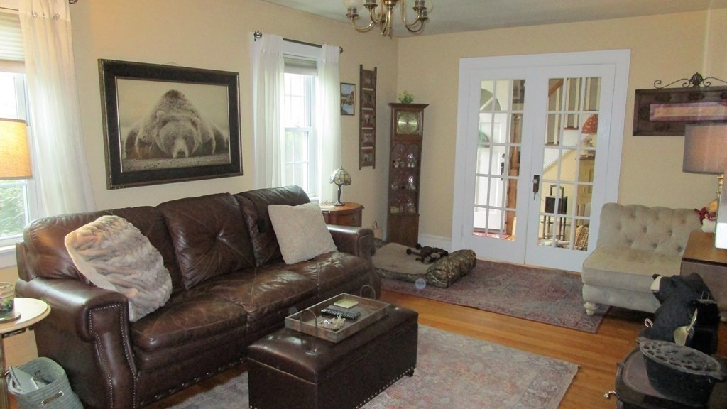 45 Upton Street Springfield, MA 01104 - Photo 9 of 19 a living room with furniture a couch and a painting on the wall
