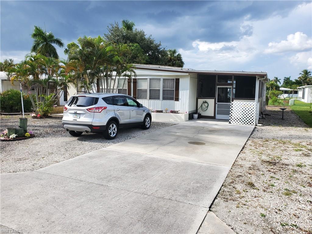 887 Manatee Road Naples, FL 34114 - Photo 3 of 7 a house view with a sitting space and garden