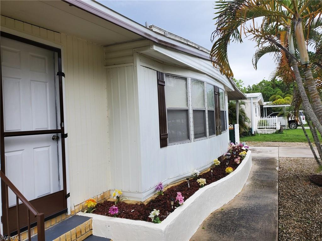 887 Manatee Road Naples, FL 34114 - Photo 4 of 7 a house with outdoor seating