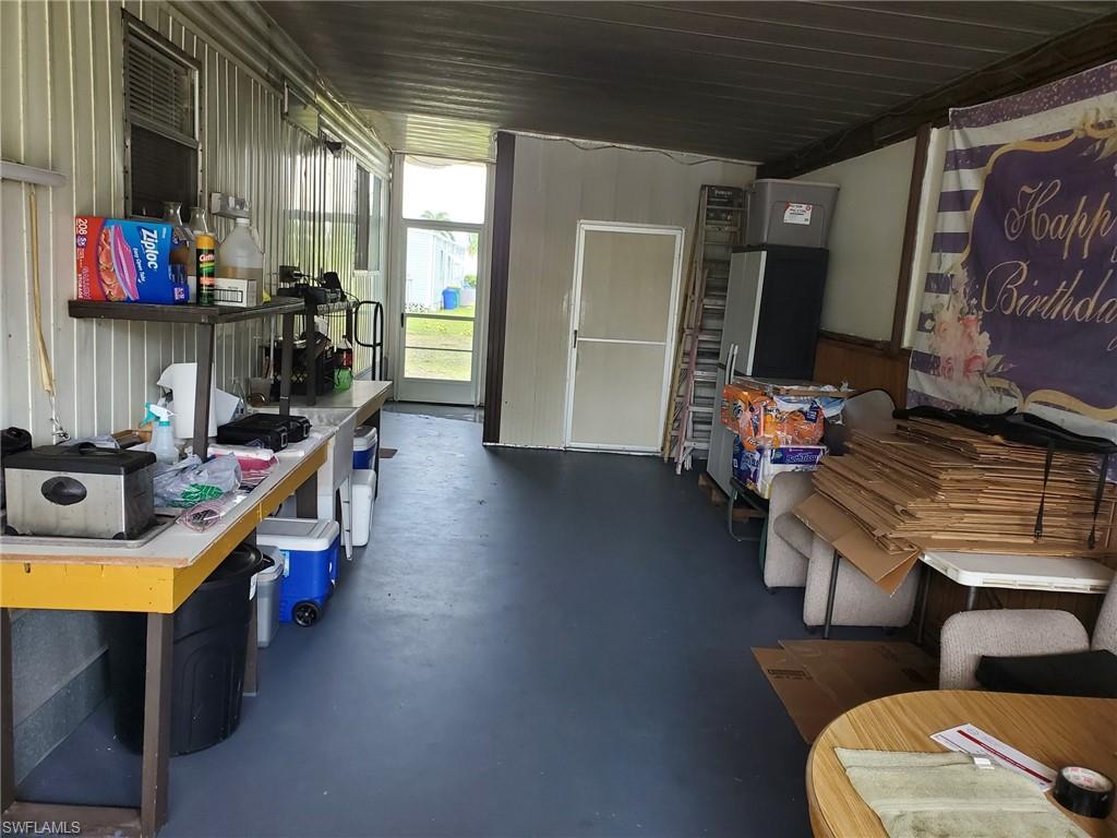 887 Manatee Road Naples, FL 34114 - Photo 7 of 7 a room with furniture and a flat screen tv