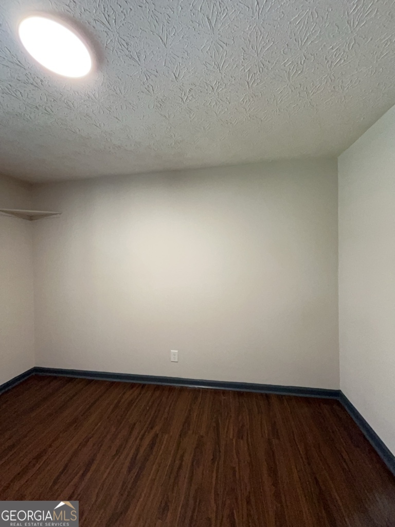 1265 Herrington Road Lawrenceville, GA 30044 - Photo 17 of 52 a view of an empty room and wooden floor