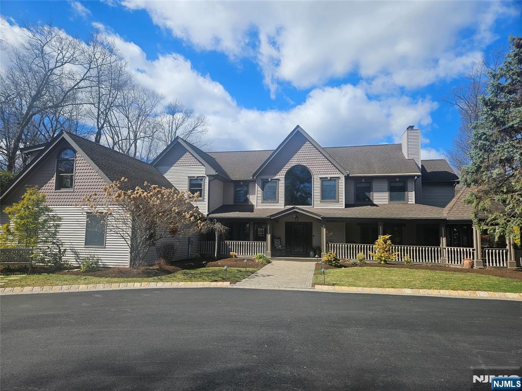 285 Chestnut Ridge Road Woodcliff Lake, NJ 07677 - Photo 2 of 46 a front view of a house with swimming pool