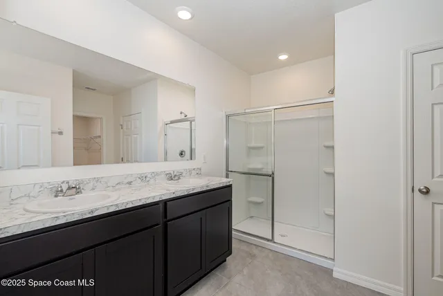 a bathroom with a granite countertop sink mirror and double