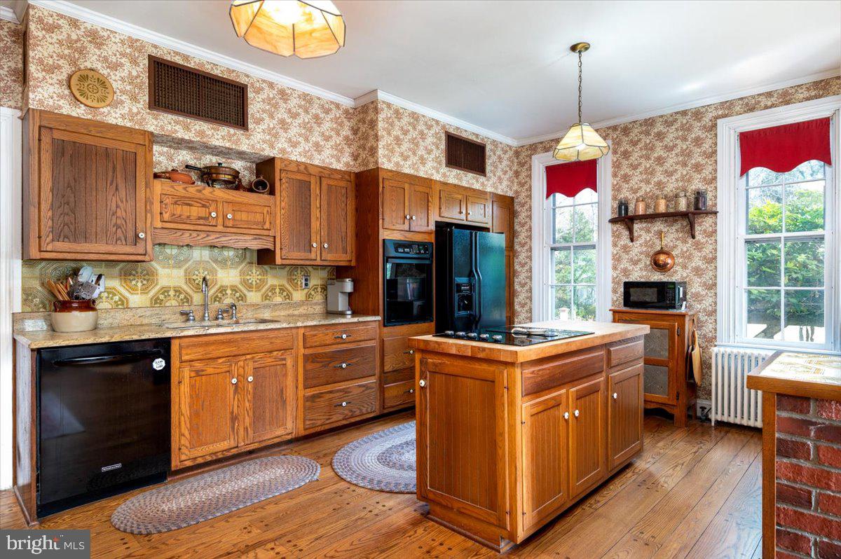 16410 St Marys Church Road Aquasco, MD 20608 - Photo 29 of 64 a kitchen with kitchen island granite countertop wooden cabinets and a stove