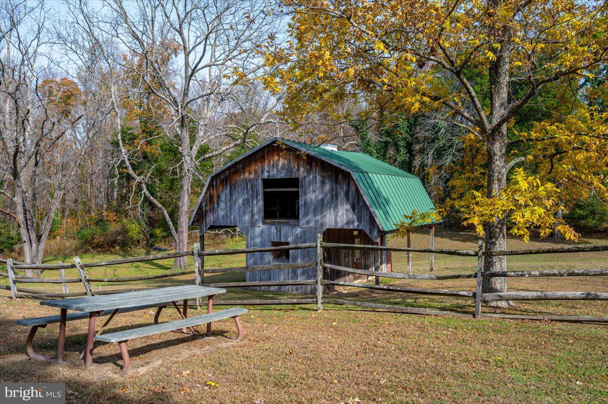 16410 St Marys Church Road Aquasco, MD 20608 - Photo 57 of 64 a view of backyard with wooden fence and trees