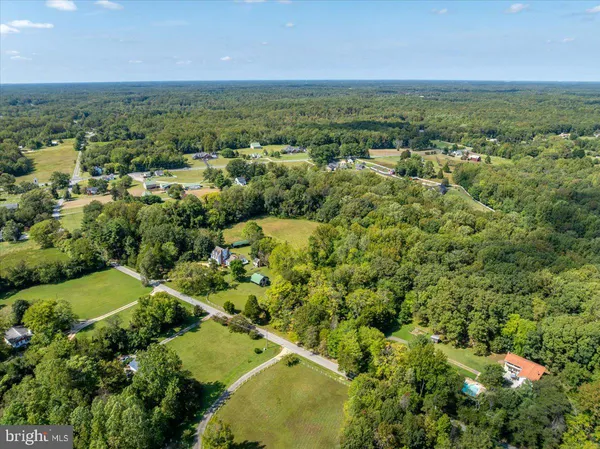 an aerial view of a residential houses with yard