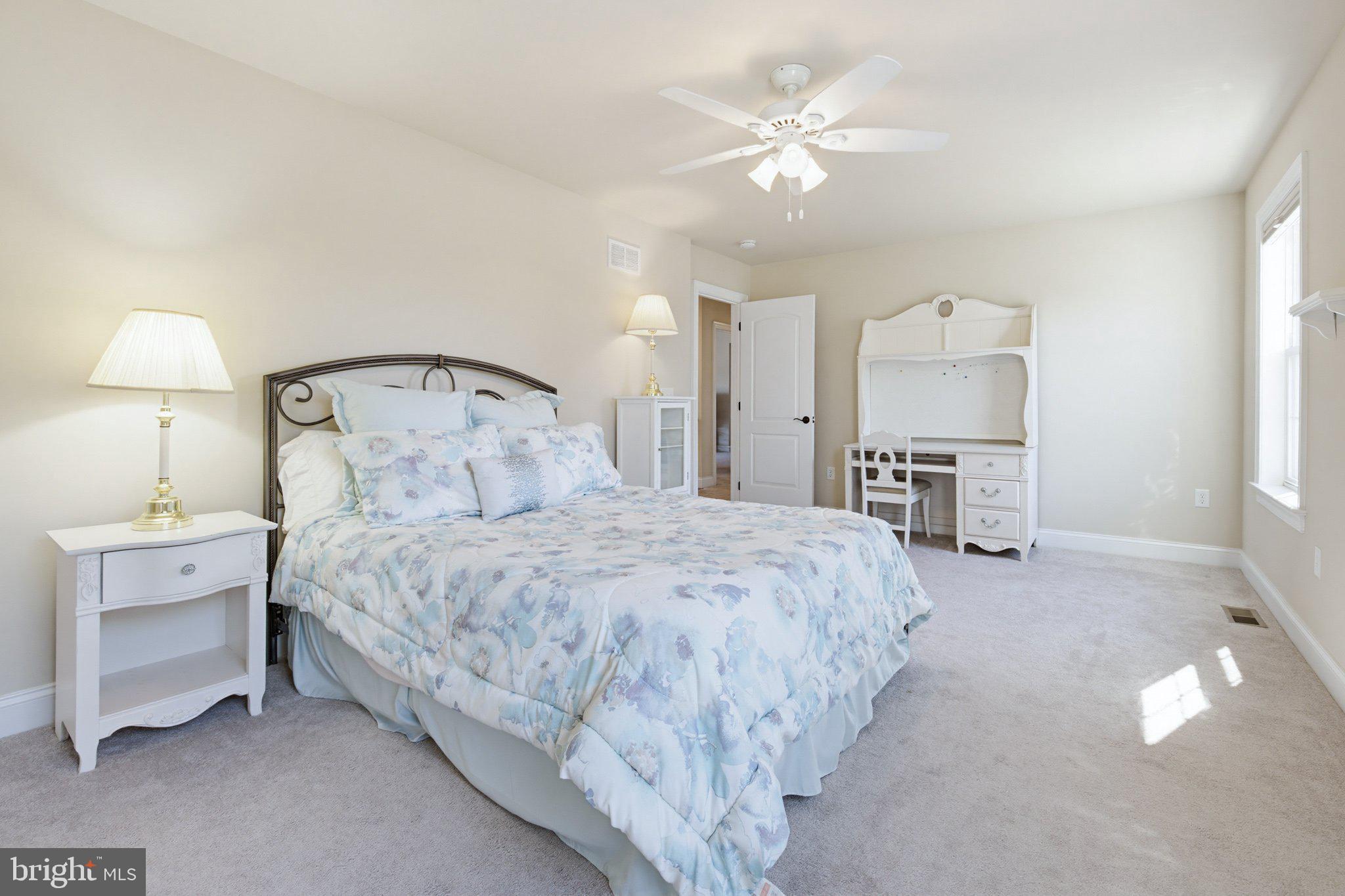 1021 Suffolk Drive Lititz, PA 17543 - Photo 28 of 44 a bedroom with a bed and a chandelier