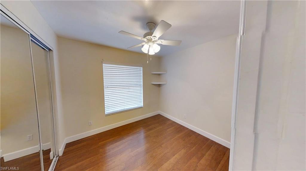 9108 Henry Road Fort Myers, FL 33967 - Photo 14 of 18 a view of an empty room with wooden floor and a window