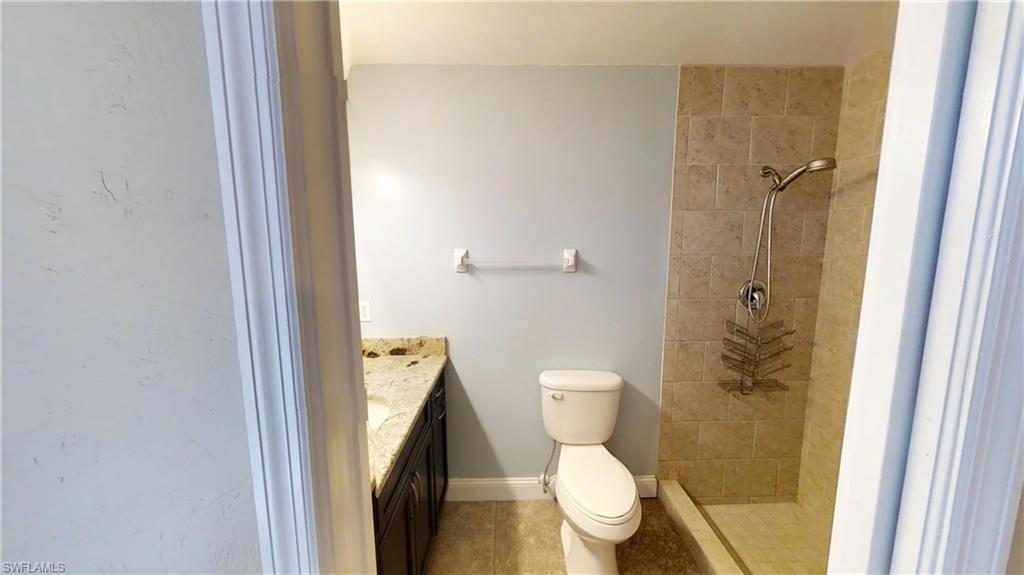 9108 Henry Road Fort Myers, FL 33967 - Photo 9 of 18 a white toilet sitting next to a shower