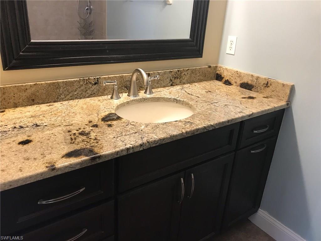9108 Henry Road Fort Myers, FL 33967 - Photo 10 of 18 a bathroom with a granite countertop sink vanity and mirror