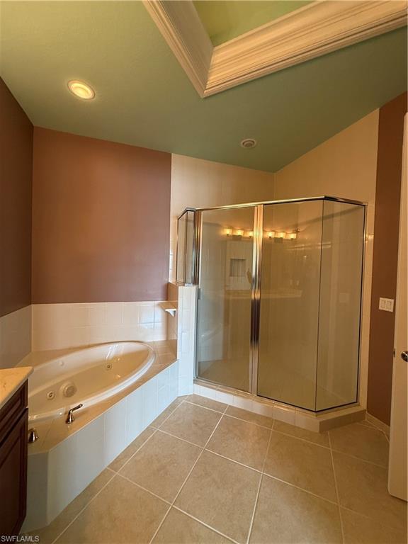 7168 Lemuria Circle, Unit 1701 Naples, FL 34109 - Photo 21 of 39 Full bath featuring a stall shower, vanity, light tile patterned floors, a jetted tub, and ornamental molding