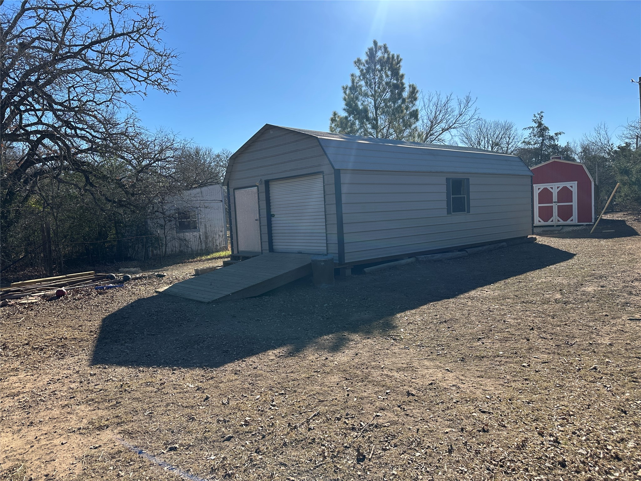 438 Mt Olive Road, Unit A Cedar Creek, TX 78612 - Photo 22 of 27 Garage with a storage shed