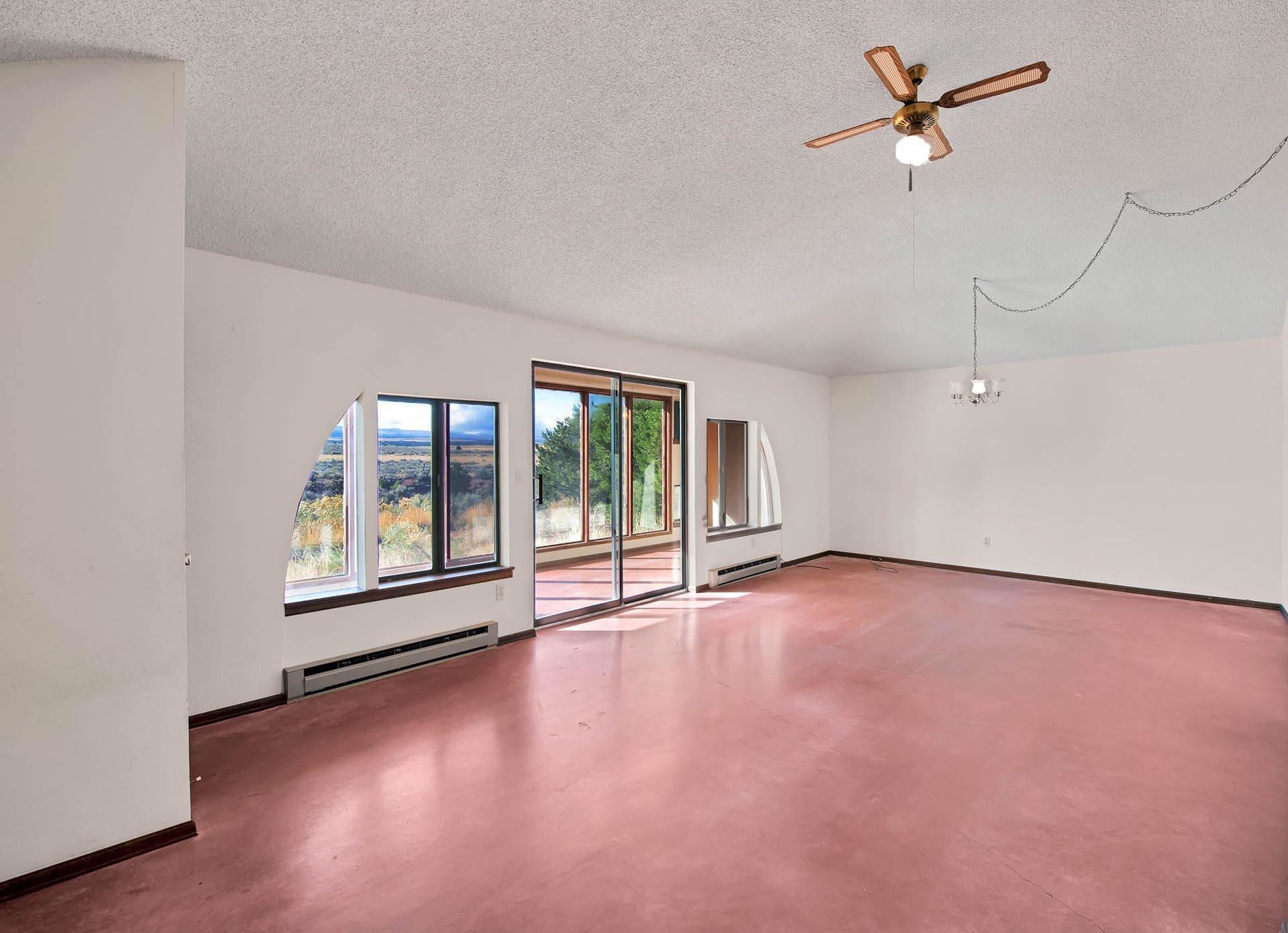 1041 South 16 1/2 Road Glade Park, CO 81523 - Photo 13 of 42 a view of an empty room with a window and wooden floor